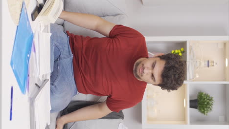 Vertical-video-of-Lazy-man-rubbing-his-hungry-stomach.